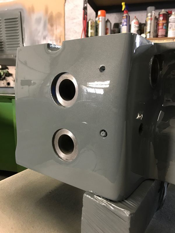 A gray box with two holes in it is sitting on a table.