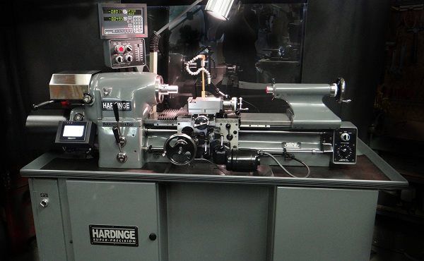 A harsange lathe is sitting on a table in a dark room.
