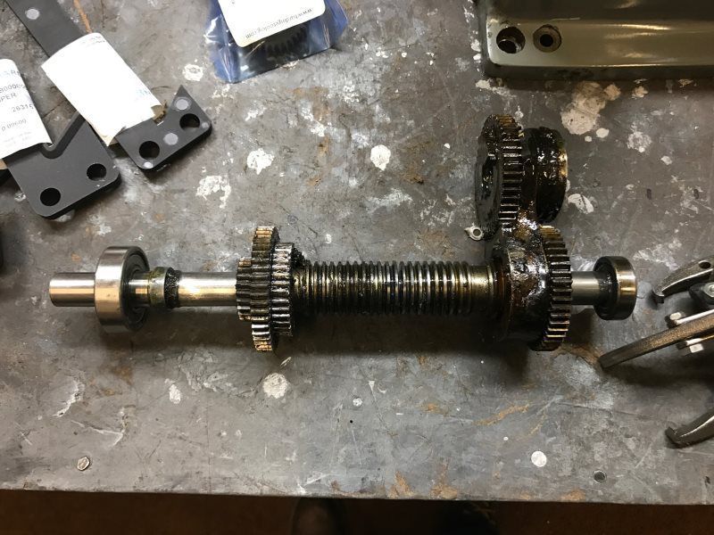 A piece of metal is sitting on top of a metal table.