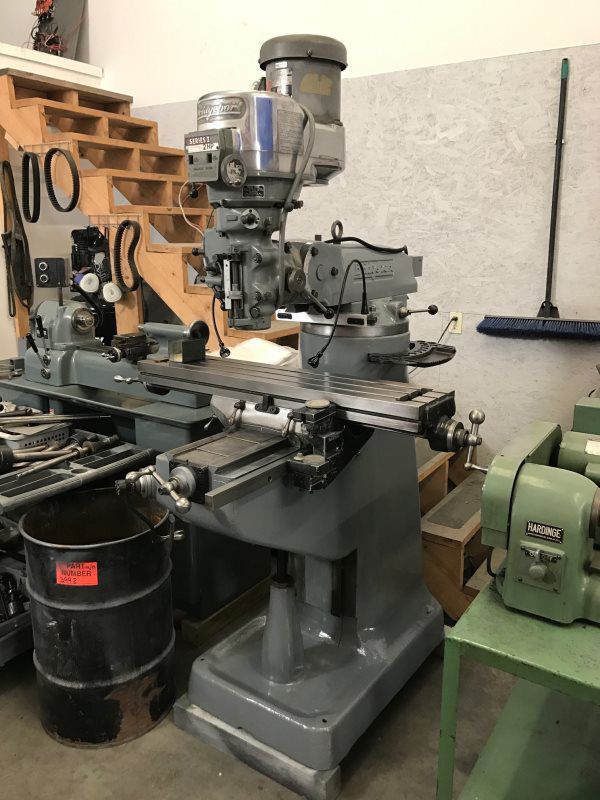 A machine is sitting in a room next to a staircase.