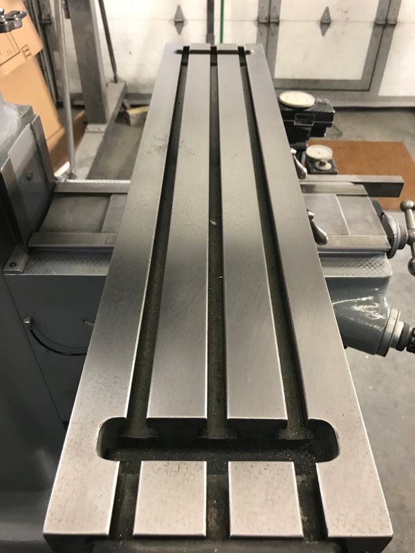 A machine is sitting in a garage and looks like a bench