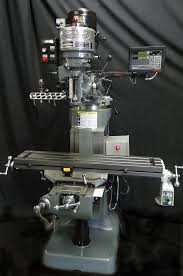 A milling machine is sitting on top of a black table.