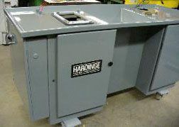 A gray metal desk with a cabinet underneath it.