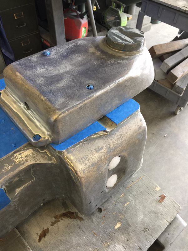 A piece of metal is sitting on top of another piece of metal on a table.