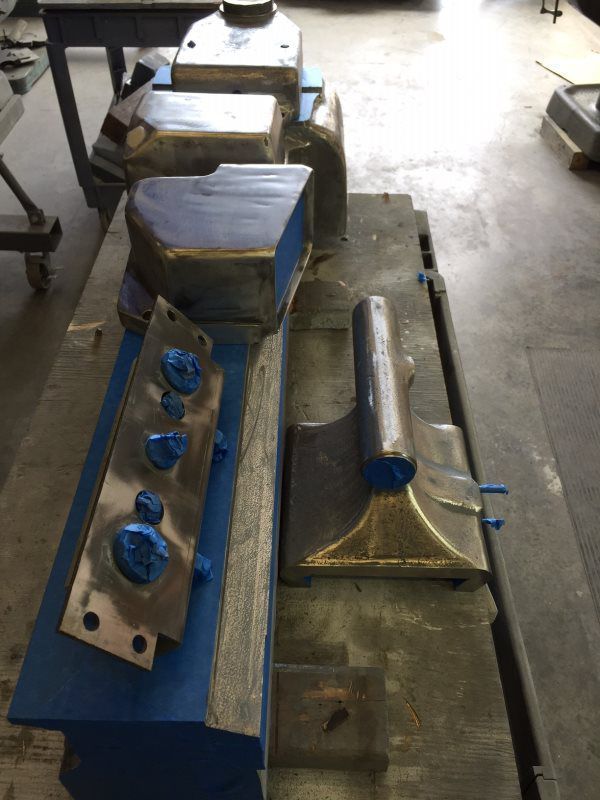 A bunch of metal pieces are sitting on a table