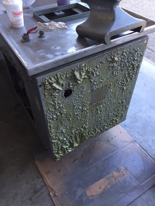 A dirty piece of metal with a hole in it