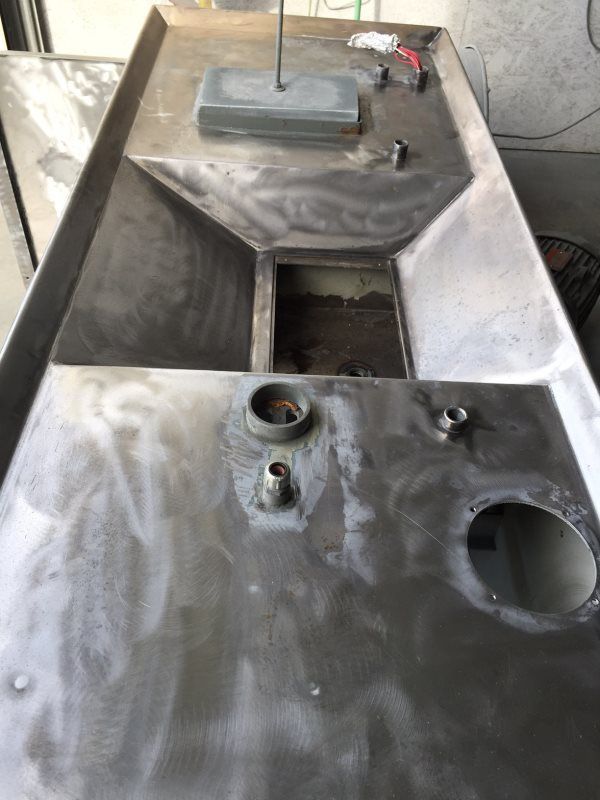 A stainless steel sink with a hole in the middle of it.