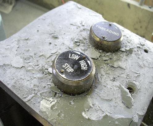 Two buttons on a concrete surface that say low high and stop