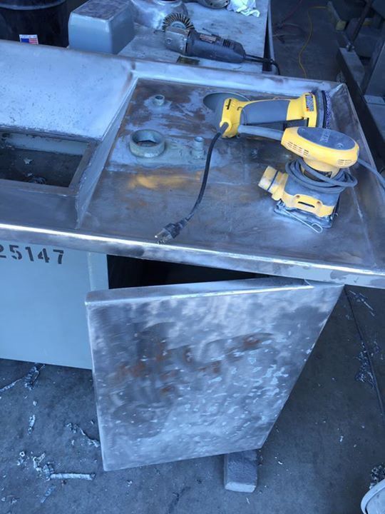 A dewalt sander is sitting on a stainless steel counter