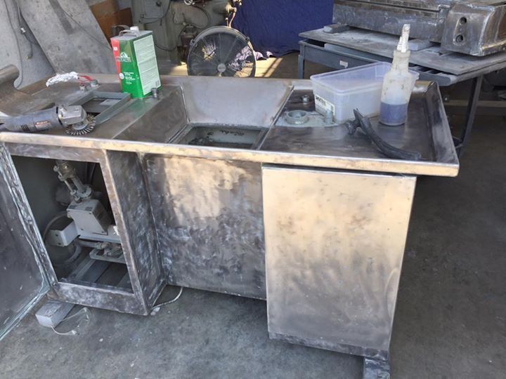 A stainless steel desk with a bottle of glue on it