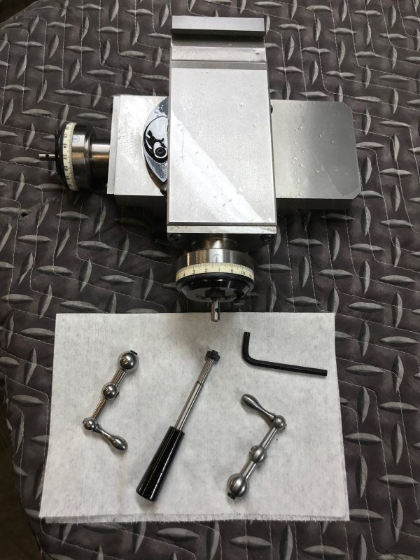 A piece of metal is sitting on top of a metal table.