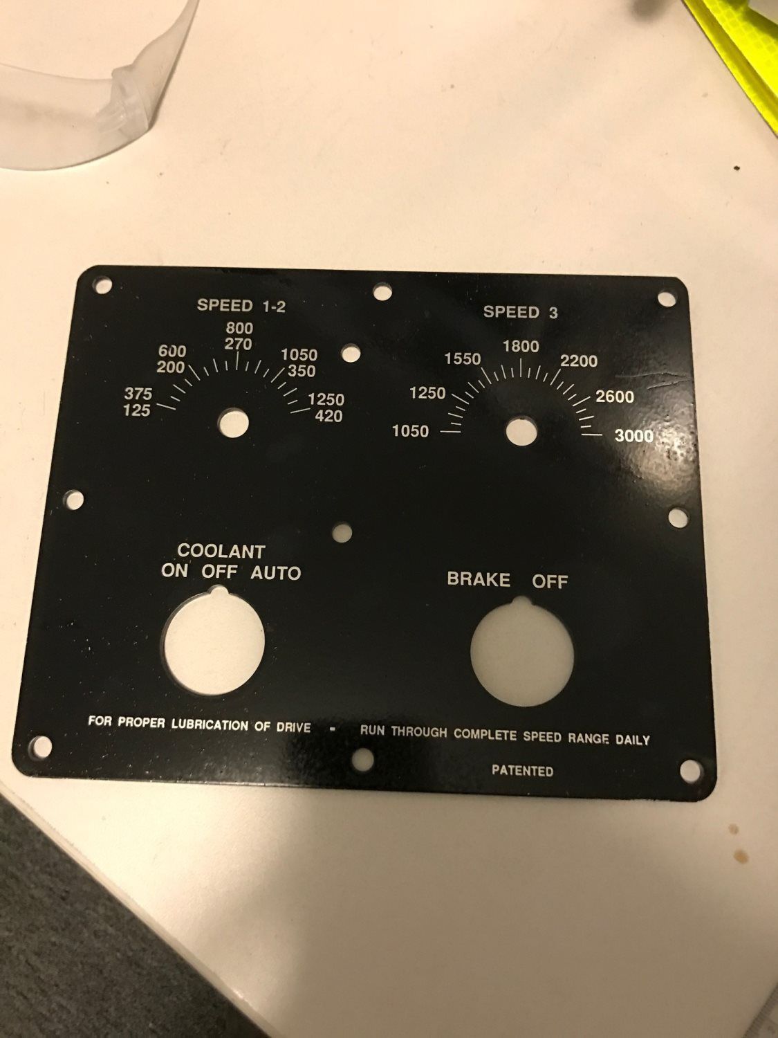 A black control panel is sitting on a white table.