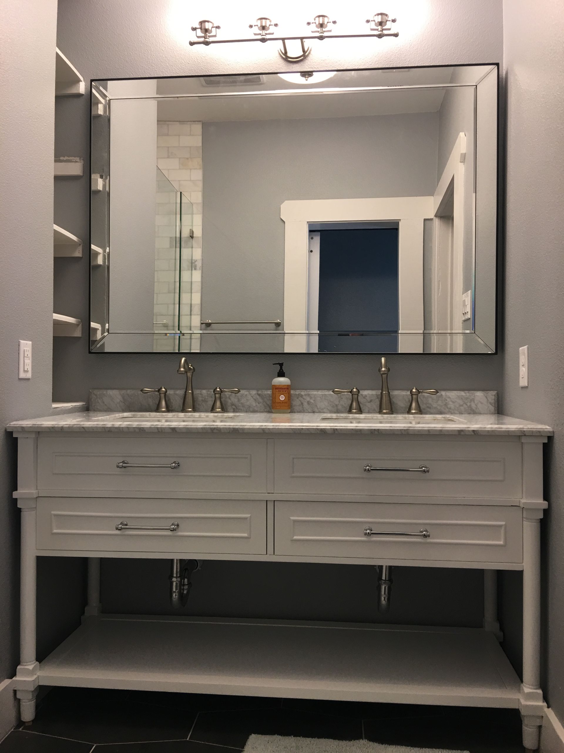 A bathroom with two sinks and a mirror