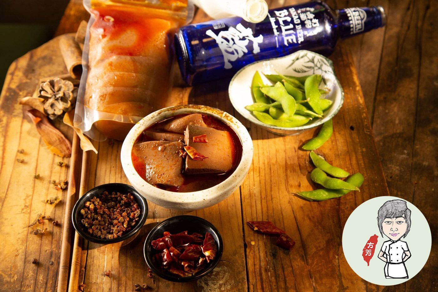 A wooden table topped with bowls of food and a bottle of alcohol.
