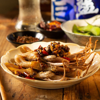 A bowl of food on a wooden table with a can of beer in the background