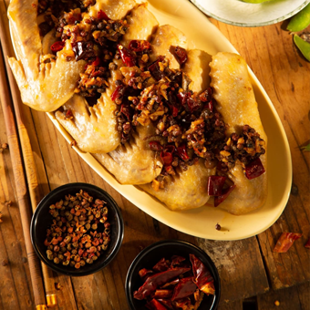 A plate of food with chopsticks on a wooden table