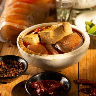 A bowl of food is sitting on a wooden table