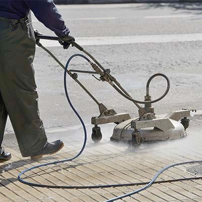 Professional Worker Cleaning a Sidewalk