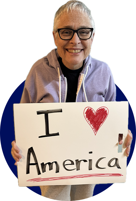 Woman holding a sign reading