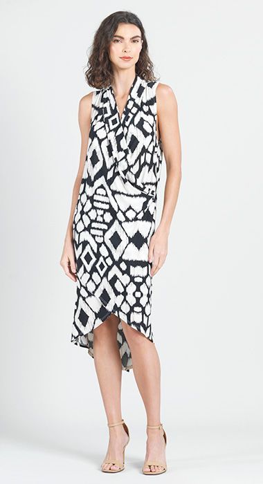 A woman is wearing a black and white dress and heels.