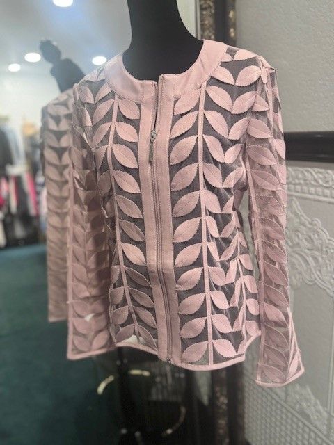 A pink jacket is on a mannequin in front of a mirror