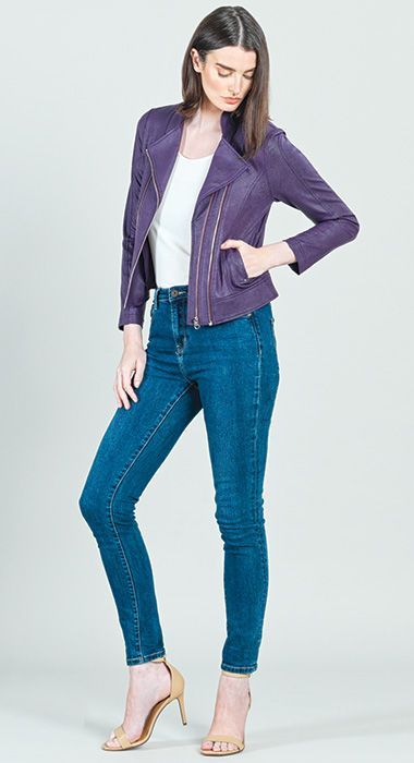 A woman is wearing a purple jacket and blue jeans.