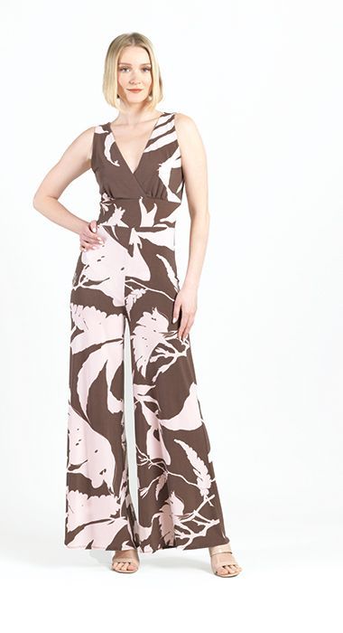 A woman is wearing a brown and pink floral jumpsuit.