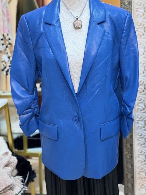 A mannequin is wearing a blue leather jacket