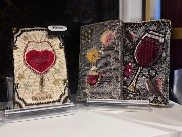 A book with a glass of wine on it is sitting on a table.