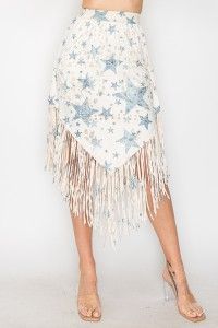 A woman is wearing a white skirt with blue stars and fringe.