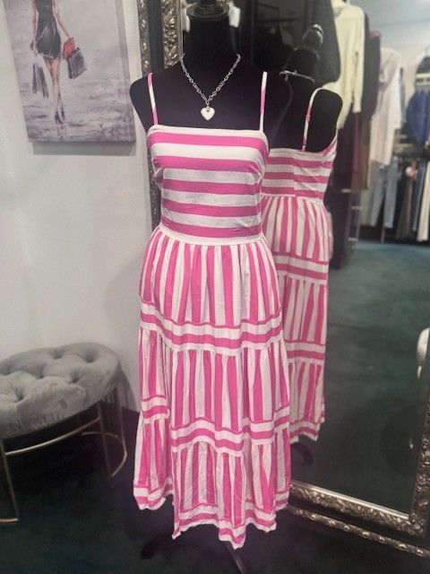 A pink and white striped dress is on a mannequin