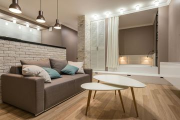 A living room with a couch and two coffee tables.