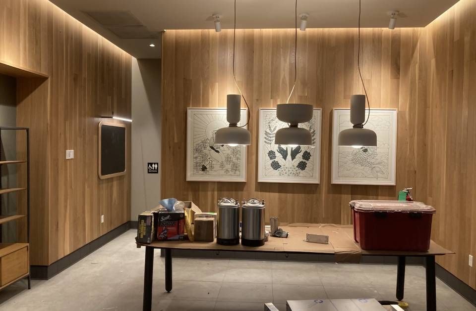 A room with wooden walls and a table with a red box on it