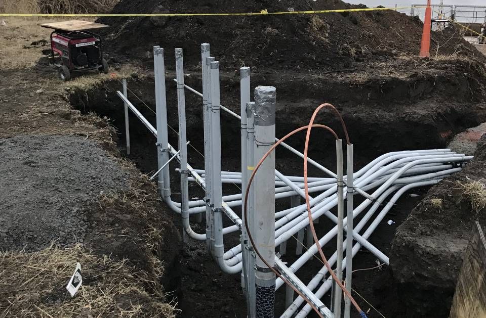 A bunch of pipes are being installed in the ground