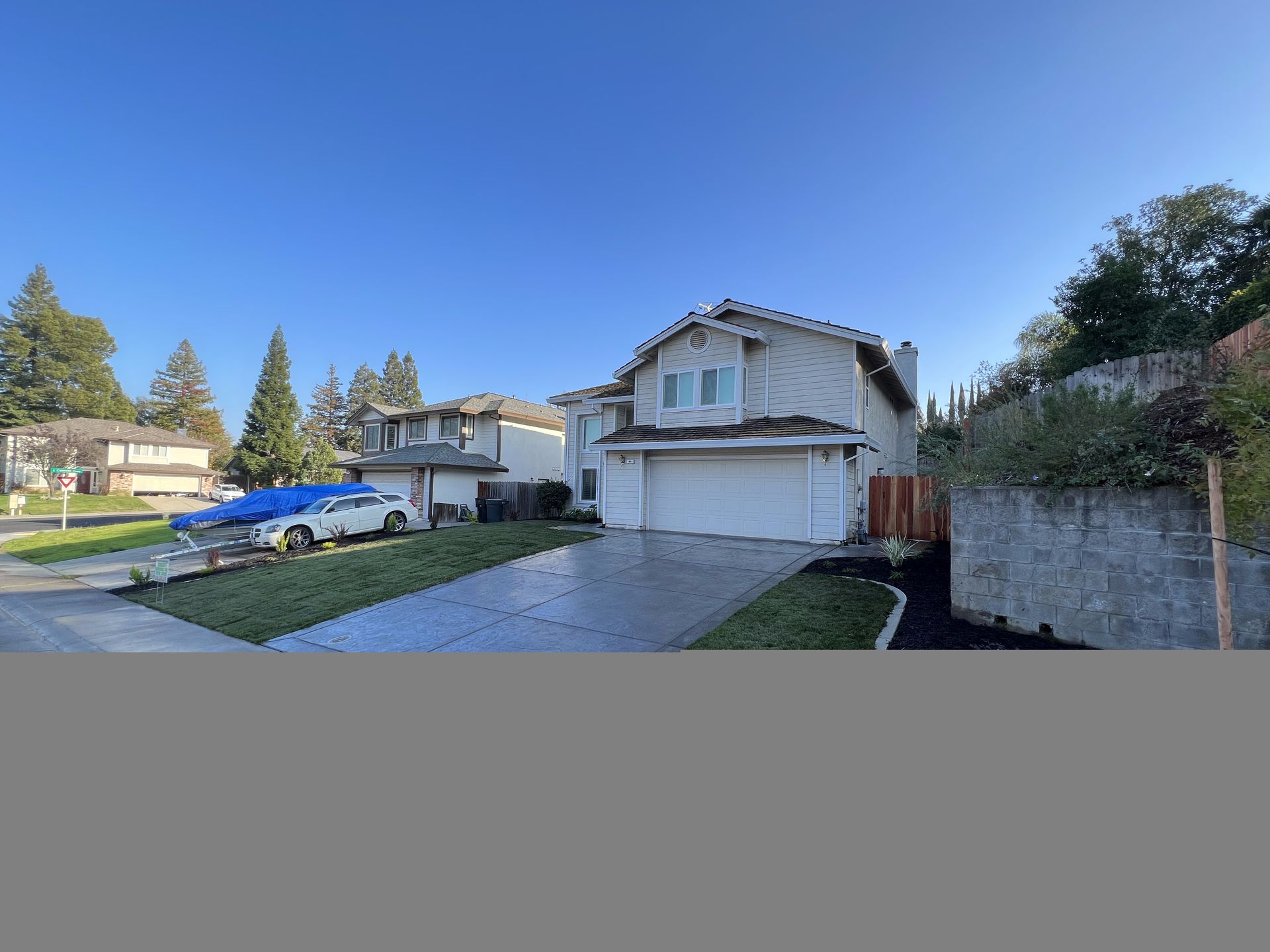 A house with a car parked in front of it in a residential area.