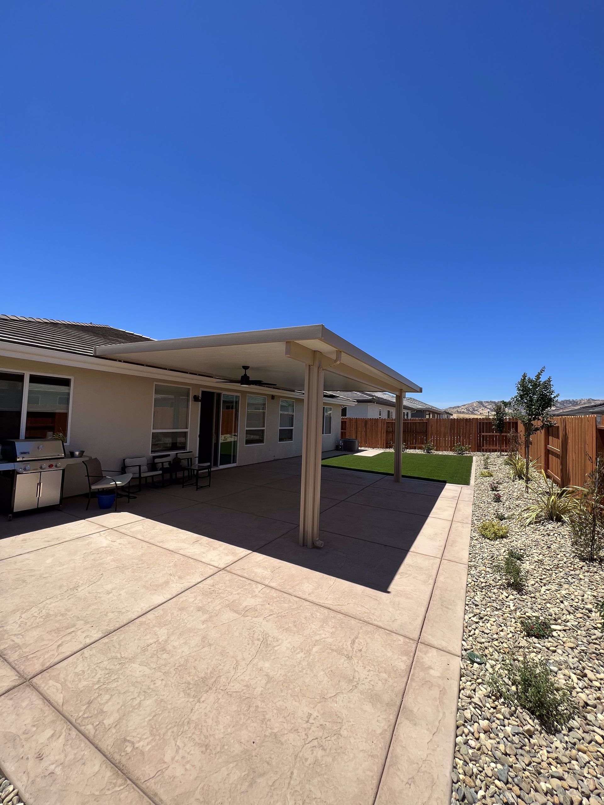 A house with a covered patio in front of it