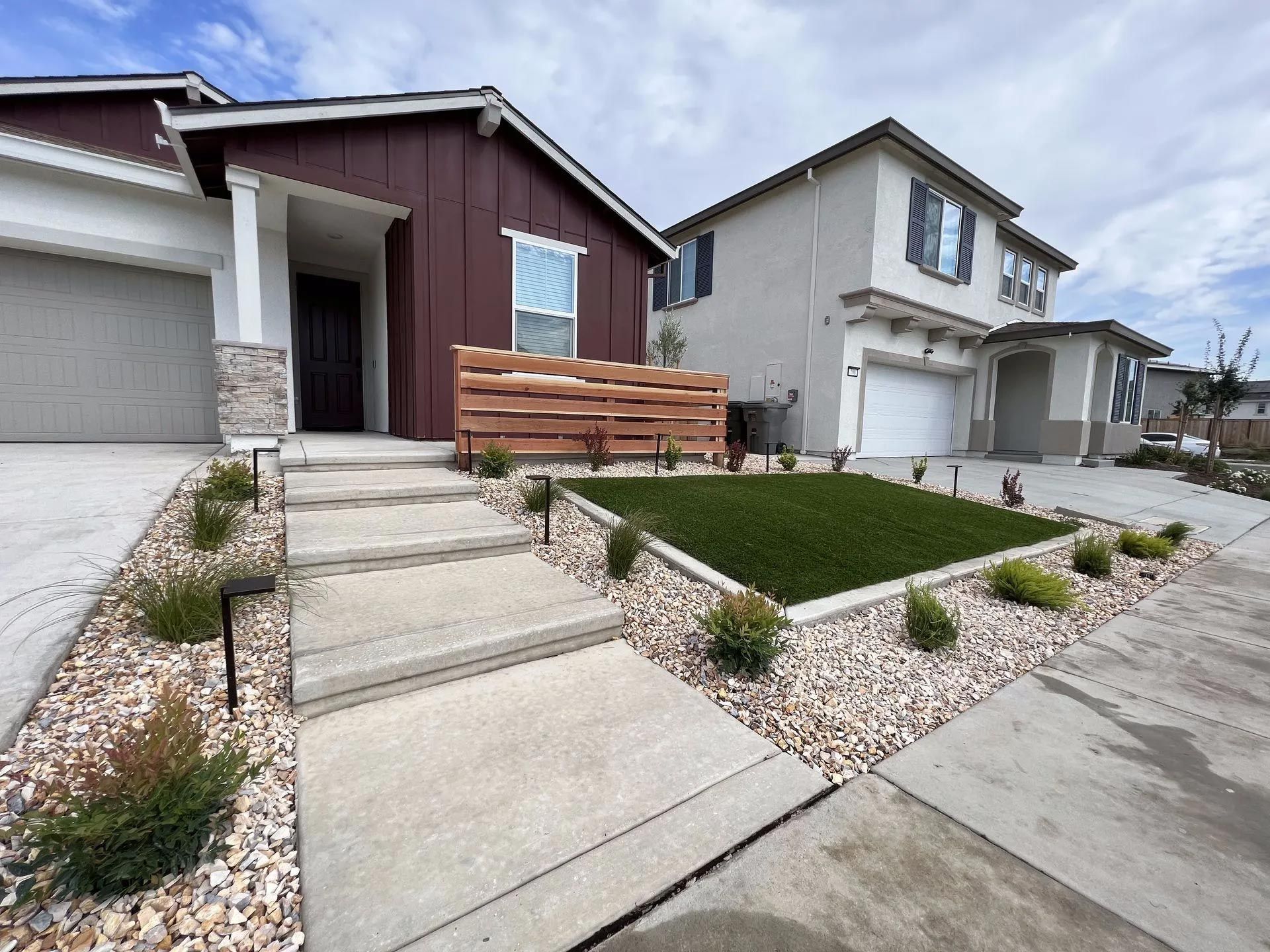A bathroom with two sinks , a mirror and a walk in shower.