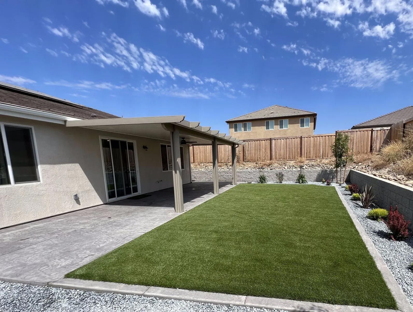 A person wearing red gloves is kneeling down on a black cloth.