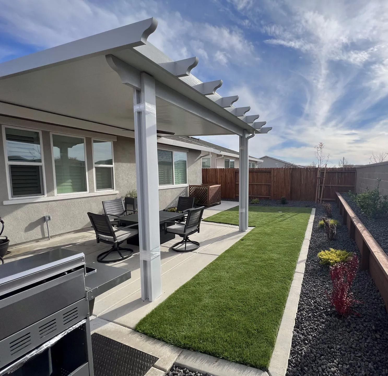 A person wearing red gloves is kneeling down on a black cloth.