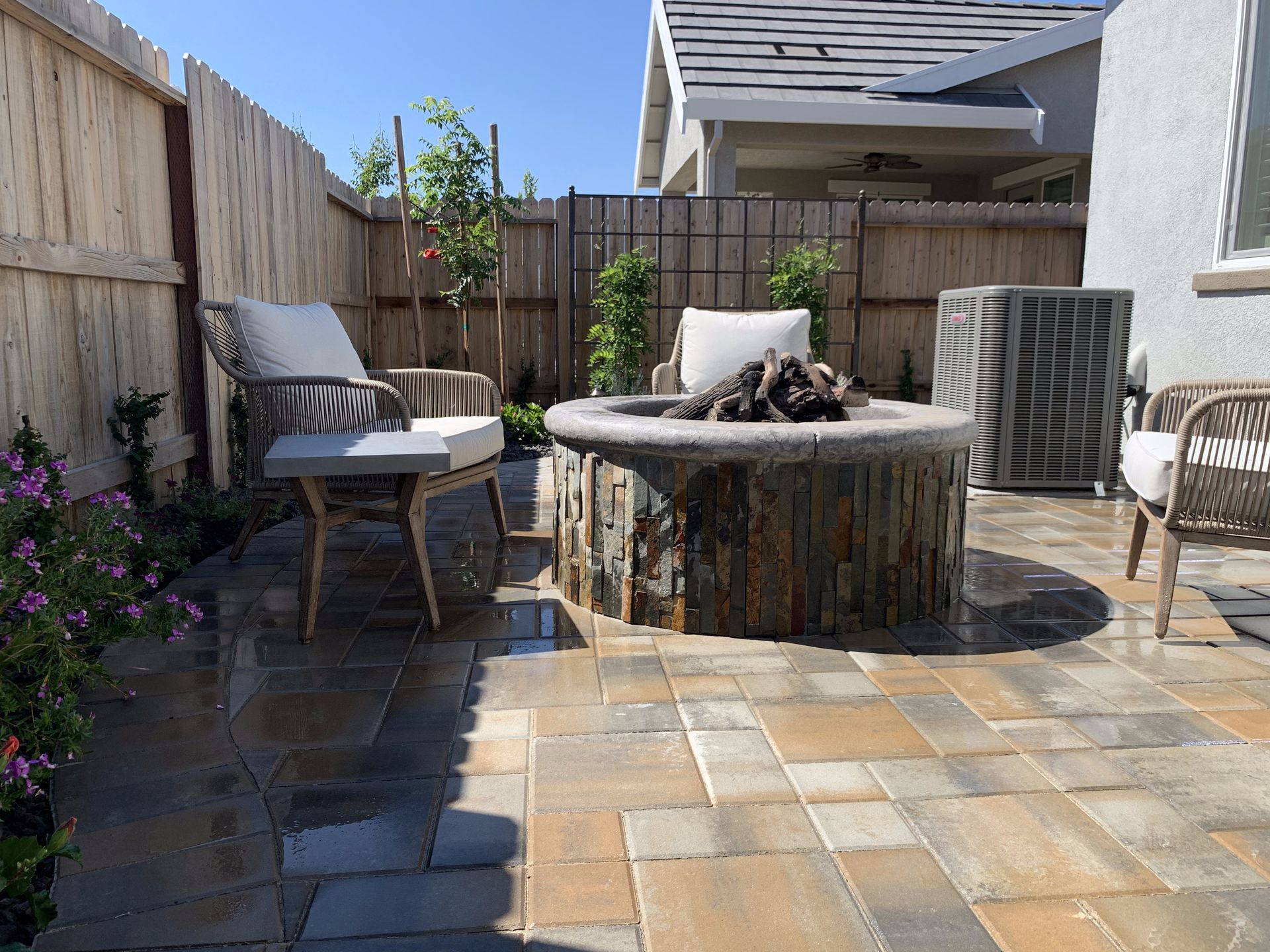 There is a fire pit in the middle of the patio.