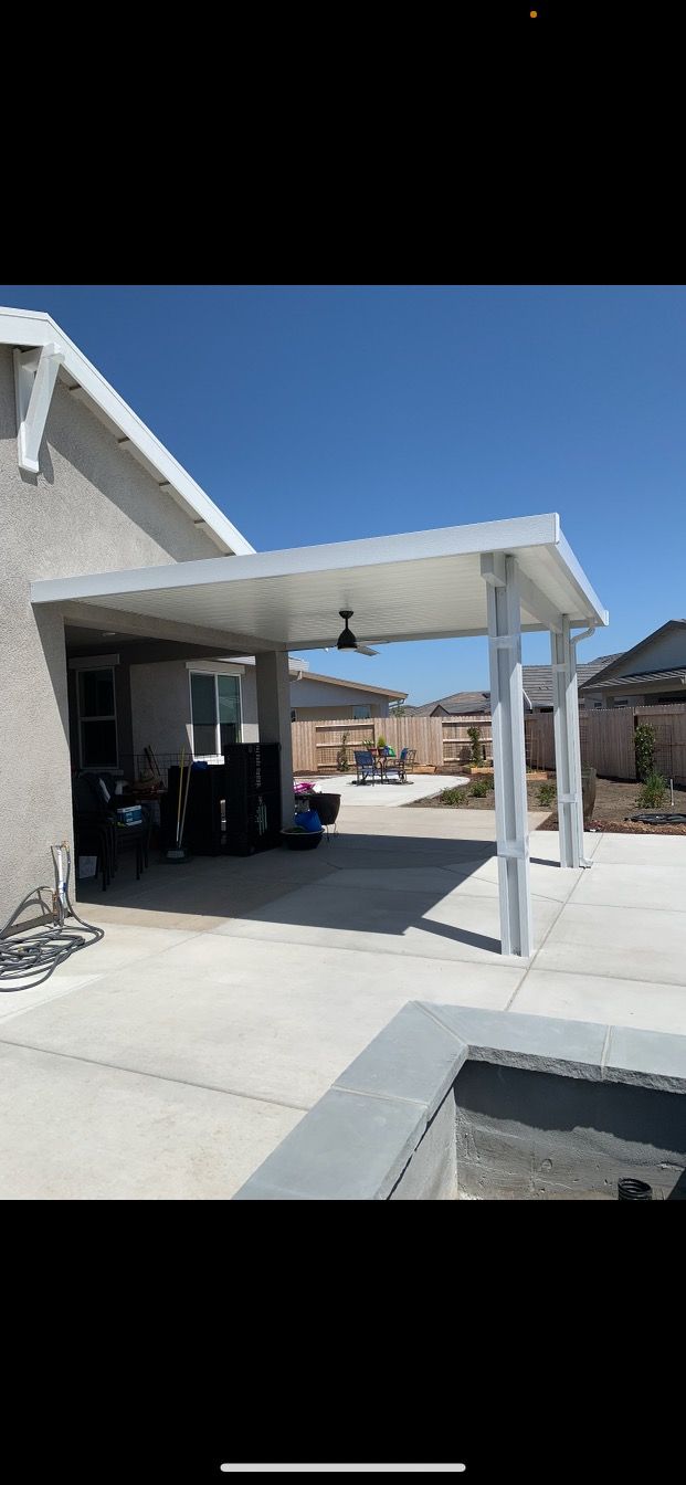 A house with a carport and a pool in the backyard.