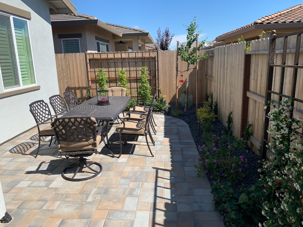 an outdoor dining area on square pavers