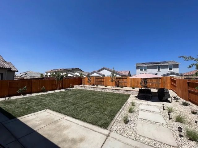 dark grass surrounded by cement pavers