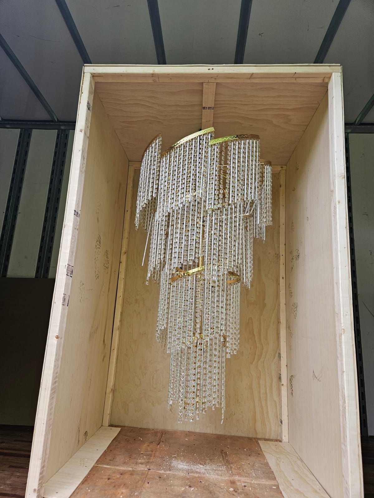 A chandelier is sitting in a wooden box.