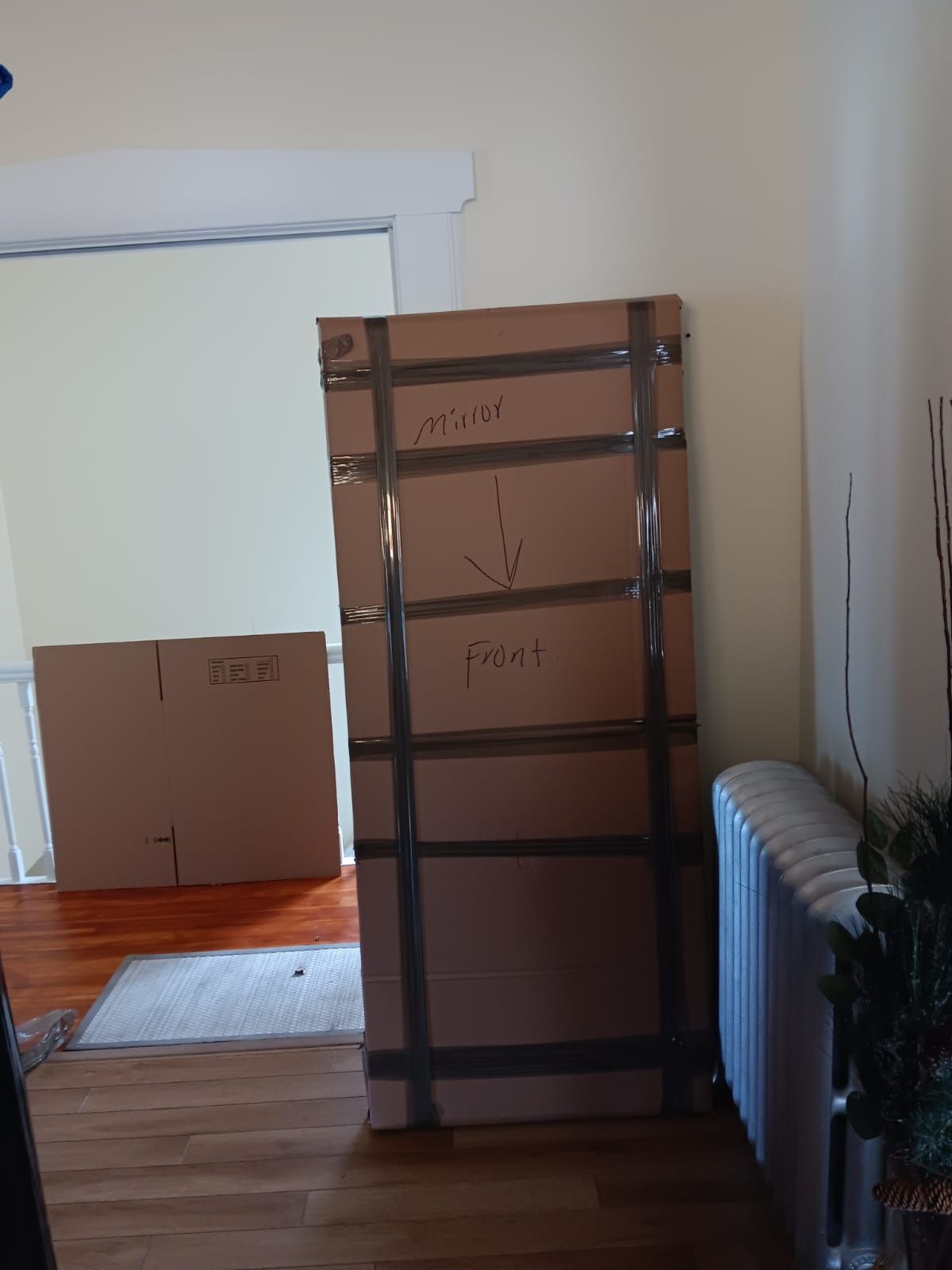 A stack of cardboard boxes in a room with arrows pointing in opposite directions