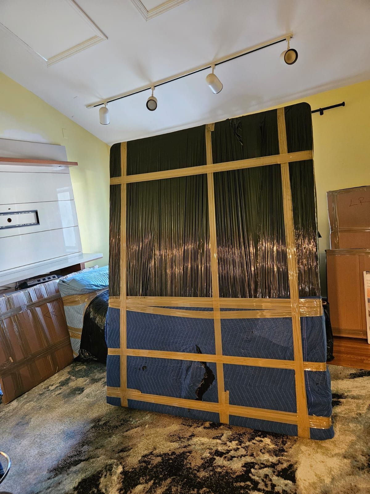 A large piece of furniture is taped to the floor in a room.