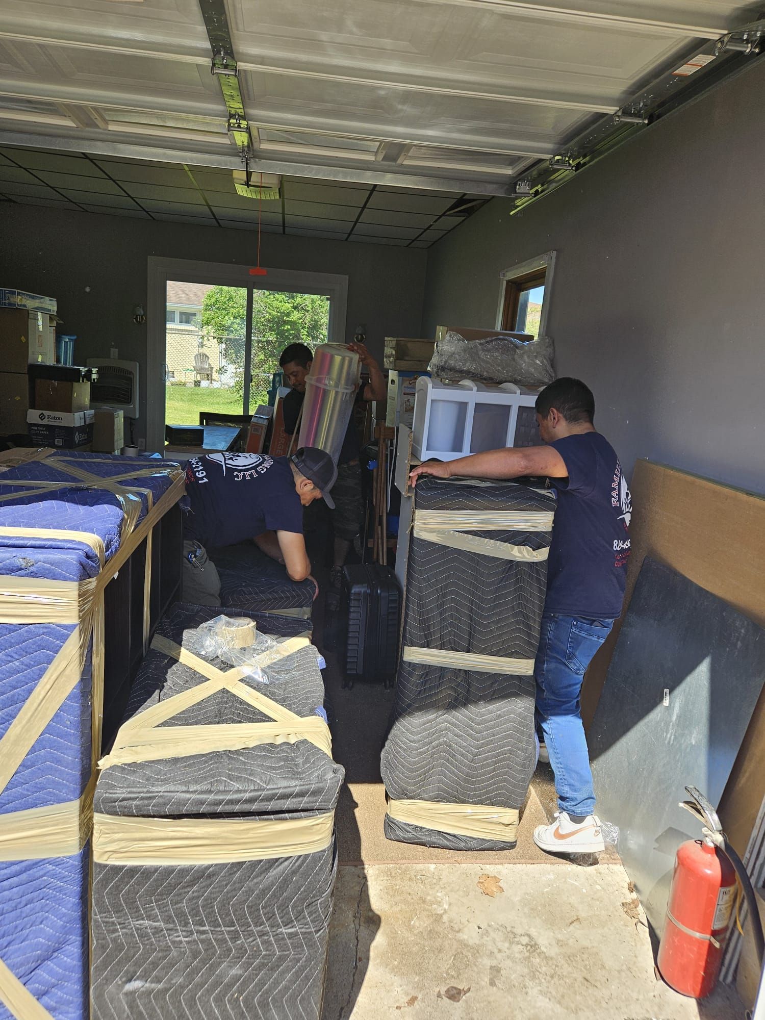 A group of men are moving furniture in a garage.