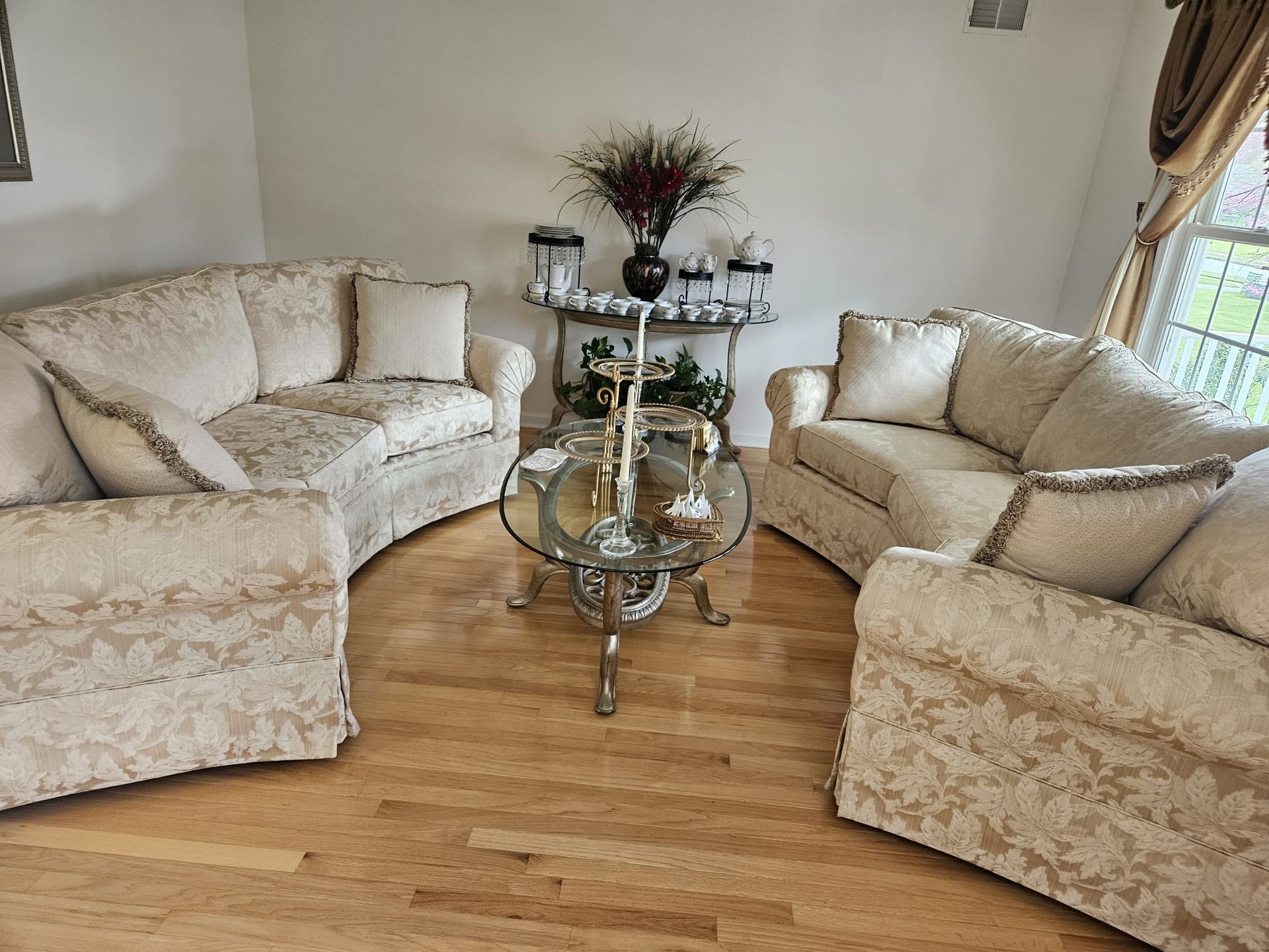 A living room with a couch , two chairs and a coffee table