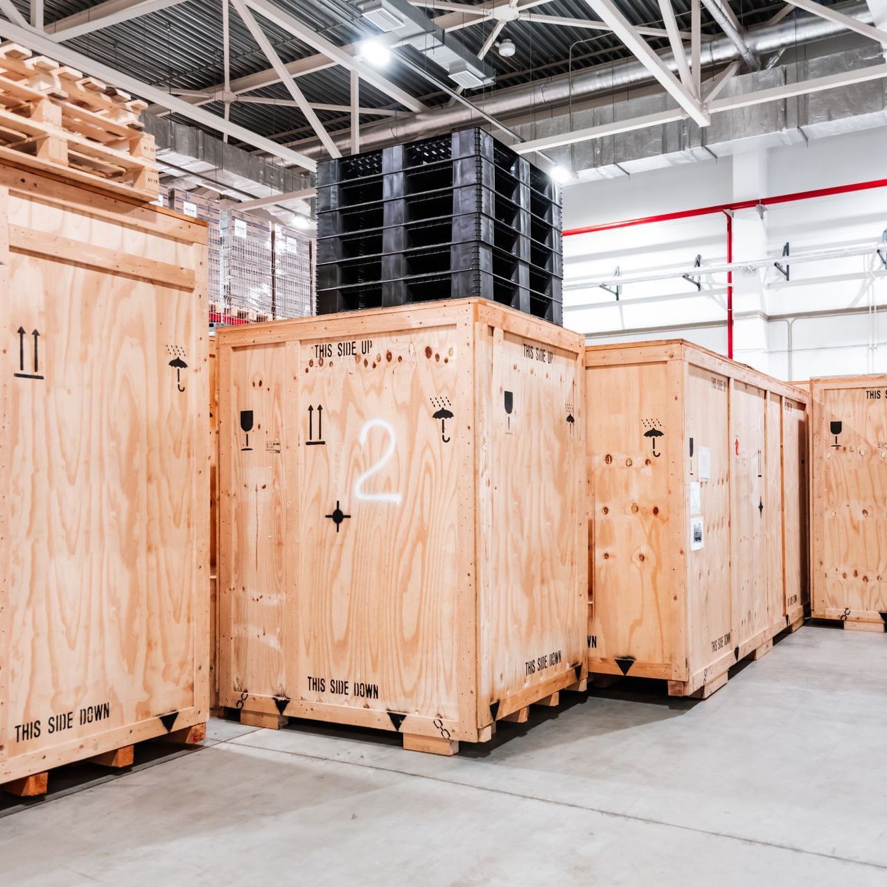 A row of wooden crates in a warehouse with the number 2 on them