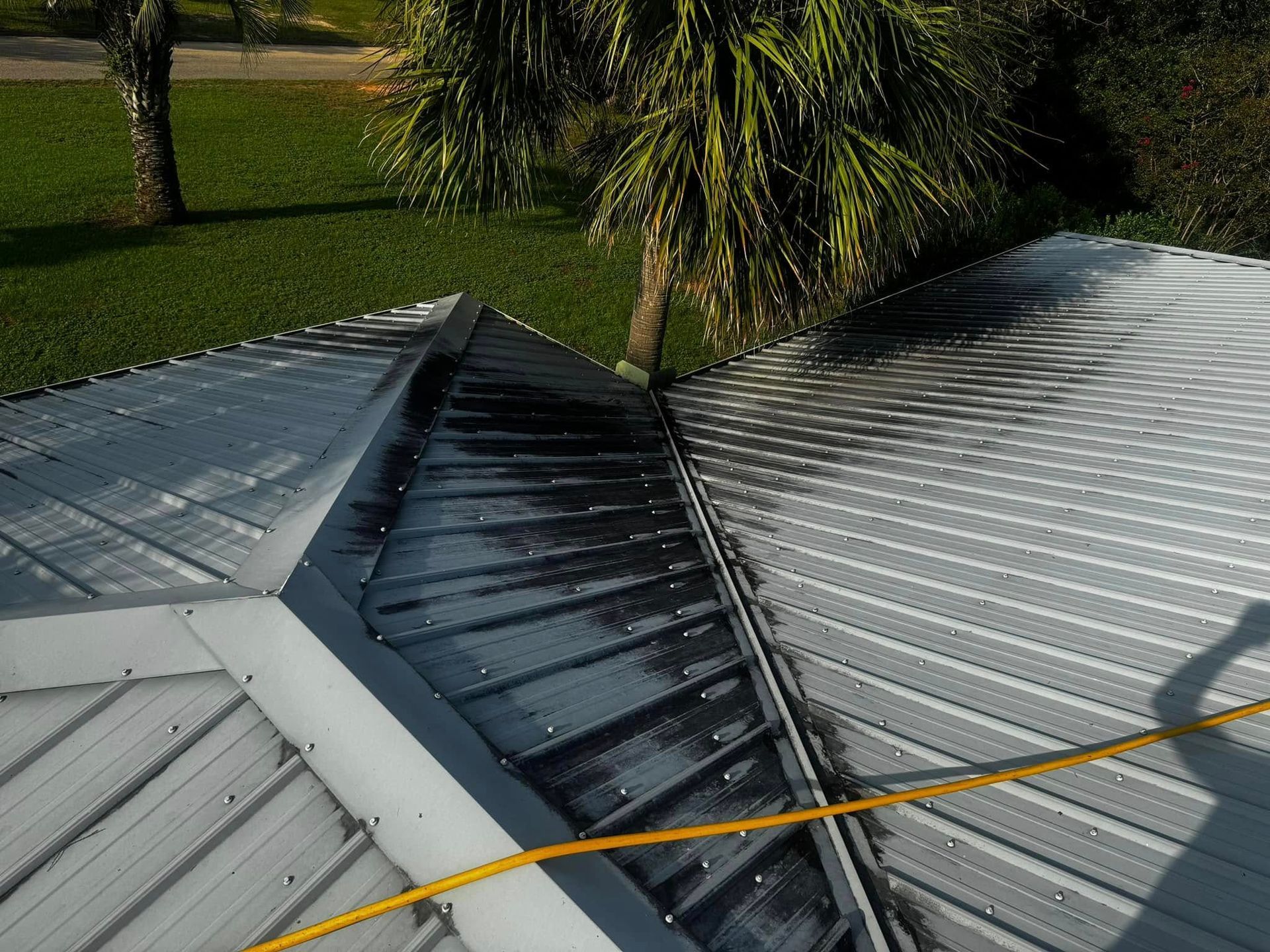 A close-up of a roof with trees in the background